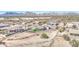 Scenic aerial shot of desert home with mountain range, fencing, and desert landscape at 1727 E Hidalgo St, Apache Junction, AZ 85119