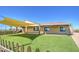 View of the backyard that is fully fenced with artificial grass at 1727 E Hidalgo St, Apache Junction, AZ 85119