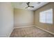 Bedroom with neutral carpet, ceiling fan, and window at 1727 E Hidalgo St, Apache Junction, AZ 85119