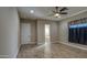 Bright bedroom with hardwood floors, ceiling fan, and walk-in closet access at 1727 E Hidalgo St, Apache Junction, AZ 85119