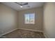 Bedroom with carpet, ceiling fan, and window offering neighborhood views at 1727 E Hidalgo St, Apache Junction, AZ 85119
