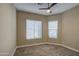 Bedroom featuring carpet, ceiling fan, and two windows at 1727 E Hidalgo St, Apache Junction, AZ 85119