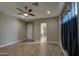 Bedroom features hardwood floors, ceiling fan, and a door leading to ensuite bathroom at 1727 E Hidalgo St, Apache Junction, AZ 85119