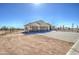 A desert home with a brick-paved driveway, three car garage and wrought iron fence at 1727 E Hidalgo St, Apache Junction, AZ 85119