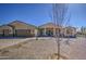 Single story desert home with a three car garage, brick-paved driveway and desert landscaping at 1727 E Hidalgo St, Apache Junction, AZ 85119