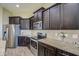 Modern kitchen features stainless steel appliances, granite countertops, and wooden cabinets at 1727 E Hidalgo St, Apache Junction, AZ 85119