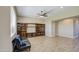 Open-concept living room with wood-look tile flooring and a built-in entertainment center at 1727 E Hidalgo St, Apache Junction, AZ 85119