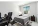 Bedroom with a modern desk, chair, and a comfortable bed, perfect for work and rest at 18006 W Hess St, Goodyear, AZ 85338