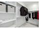 Walk-in closet with shelving on one side and hanging clothes and storage on the other at 18006 W Hess St, Goodyear, AZ 85338