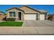 Charming single-story home with a well-manicured lawn and a spacious three-car garage at 18006 W Hess St, Goodyear, AZ 85338