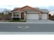 Charming single-story home with a three-car garage and well-manicured front yard at 18006 W Hess St, Goodyear, AZ 85338