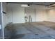Spacious garage featuring painted walls and doors with utilities off to one side at 18006 W Hess St, Goodyear, AZ 85338