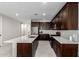 Well-equipped kitchen with stainless steel appliances, generous countertops, and dark wood cabinetry at 18006 W Hess St, Goodyear, AZ 85338