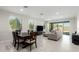 Spacious open living room with dining area, tile floors, and a view to the outdoor pool at 18006 W Hess St, Goodyear, AZ 85338