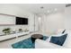 Comfortable living room with a sofa and television, perfect for relaxation at 18006 W Hess St, Goodyear, AZ 85338