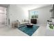 Bright living room furnished with a sofa and accent tables on top of tile flooring at 18006 W Hess St, Goodyear, AZ 85338