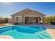 Backyard view featuring a beautiful pool with a spacious deck at 18006 W Hess St, Goodyear, AZ 85338