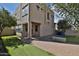 A spacious backyard features artificial turf, a paved patio, and exterior views of the home at 1930 E Hayden Ln # 118, Tempe, AZ 85281