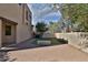 A spacious backyard features artificial turf, a paved patio, and a concrete bench at 1930 E Hayden Ln # 118, Tempe, AZ 85281