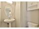 The powder room includes a pedestal sink and storage cabinet at 1930 E Hayden Ln # 118, Tempe, AZ 85281