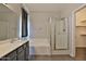 Bright bathroom features a shower over tub with glass enclosure and modern vanity at 1930 E Hayden Ln # 118, Tempe, AZ 85281