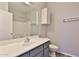 Bathroom with grey vanity, white sink and toilet, cabinet storage, and a shower-tub combo at 1930 E Hayden Ln # 118, Tempe, AZ 85281