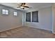 Comfortable bedroom with carpeted floors, ceiling fan, and two windows for natural light at 1930 E Hayden Ln # 118, Tempe, AZ 85281