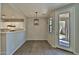 Dining area with tile floors, modern lighting, and a clear view of the stylish kitchen, creating a seamless living space at 1930 E Hayden Ln # 118, Tempe, AZ 85281