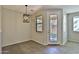 Bright dining area with tile flooring, modern light fixture, and a door to the backyard, perfect for entertaining at 1930 E Hayden Ln # 118, Tempe, AZ 85281