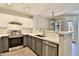 Well lit kitchen features stainless steel appliances, white countertops, and gray cabinets at 1930 E Hayden Ln # 118, Tempe, AZ 85281