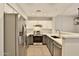 Modern kitchen features stainless steel appliances, stone countertops, and gray and white cabinets at 1930 E Hayden Ln # 118, Tempe, AZ 85281