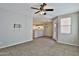 Bright living room with tile flooring, ceiling fan, and open access to the kitchen, perfect for gatherings at 1930 E Hayden Ln # 118, Tempe, AZ 85281