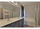 Main bathroom features double sinks, vanity and a glass shower, and separate tub at 1930 E Hayden Ln # 118, Tempe, AZ 85281
