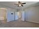 Large main bedroom includes plush carpet, ceiling fan and multiple entry points with neutral walls at 1930 E Hayden Ln # 118, Tempe, AZ 85281