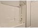 A full view of the bath and shower complete with white tiles, shower head, faucet, and tub spout at 1930 E Hayden Ln # 118, Tempe, AZ 85281