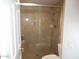 Walk-in shower featuring neutral tilework, a glass door, and a built-in bench at 19420 N Westbrook Pkwy # 510, Peoria, AZ 85382
