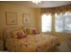 Cozy bedroom featuring yellow walls, a patterned bedspread, and a large window at 19420 N Westbrook Pkwy # 510, Peoria, AZ 85382