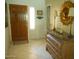 Foyer features a decorative wooden door, tiled floor, and a marble-topped console table with lamps at 19420 N Westbrook Pkwy # 510, Peoria, AZ 85382