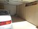Well-organized garage featuring ample storage cabinets, a white car, and interior access at 19420 N Westbrook Pkwy # 510, Peoria, AZ 85382