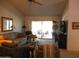 Bright living room featuring a neutral color palette, comfortable furnishings, and sliding glass doors to the patio at 19420 N Westbrook Pkwy # 510, Peoria, AZ 85382