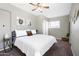 Bright bedroom features a ceiling fan, a window providing natural light, and neutral walls at 2044 W 1St St, Mesa, AZ 85201