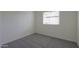 Neutral bedroom featuring light walls, plush carpeting, and a bright window at 205 S Higley Rd # 52, Mesa, AZ 85206