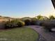 Spacious backyard featuring a well-manicured lawn, patio, desert landscape, and mountain views at 2206 W Eagle Feather Rd, Phoenix, AZ 85085