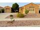 Single-story beige home boasts desert landscaping with cacti and a rock front yard at 2206 W Eagle Feather Rd, Phoenix, AZ 85085