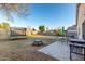 Large yard with patio furniture, grill, trampoline, and sparse landscaping at 2225 E Andalusian Loop, San Tan Valley, AZ 85140