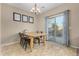 Cozy dining area features a wood table with four chairs and sliding glass doors to the backyard at 2225 E Andalusian Loop, San Tan Valley, AZ 85140