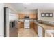 Spacious kitchen showcasing stainless steel refrigerator, white appliances, and ample cabinet space at 2225 E Andalusian Loop, San Tan Valley, AZ 85140