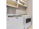 Bright laundry room featuring washer, dryer and storage shelves at 2225 E Andalusian Loop, San Tan Valley, AZ 85140