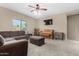 Comfortable living room with plush seating, and a decorative piano at 2225 E Andalusian Loop, San Tan Valley, AZ 85140