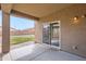 View of back patio with sliding glass door and view of green backyard at 23619 W Harrison Dr, Buckeye, AZ 85326